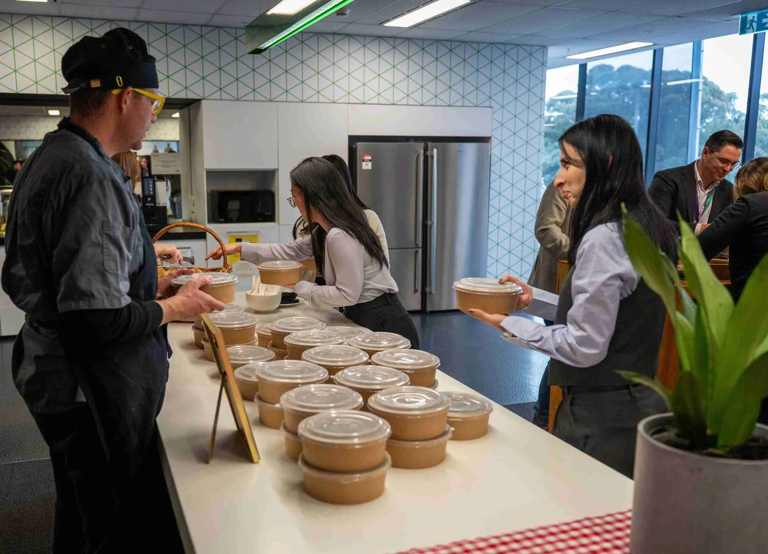 Chef serving corporate catering at Sydney office event