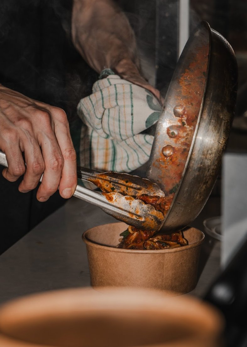 Fresh pasta being plated at event